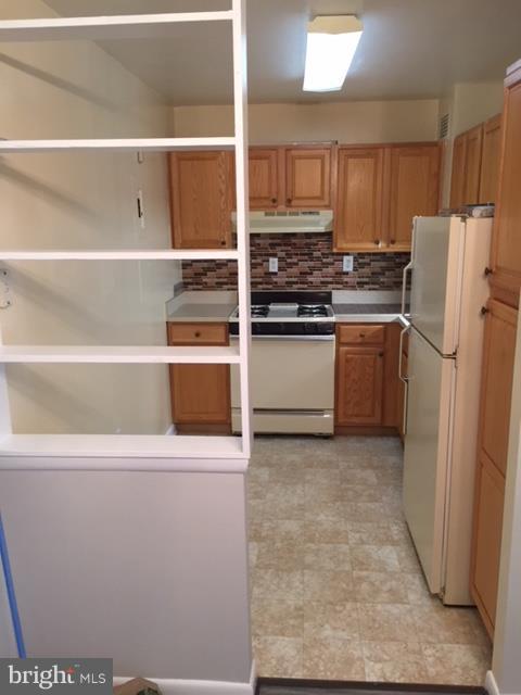 130 Slade Avenue, Unit 302 Baltimore, MD 21208 - Photo 3 of 5 a kitchen with stainless steel appliances a refrigerator stove and cabinets