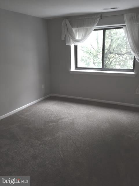 130 Slade Avenue, Unit 302 Baltimore, MD 21208 - Photo 4 of 5 an empty room with a window
