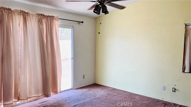 a view of room with a window and a fan