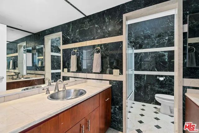 a kitchen with a sink and large windows