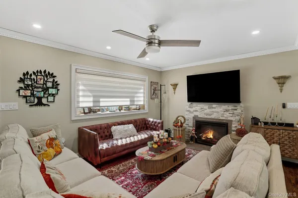 a living room with fireplace furniture and a flat screen tv