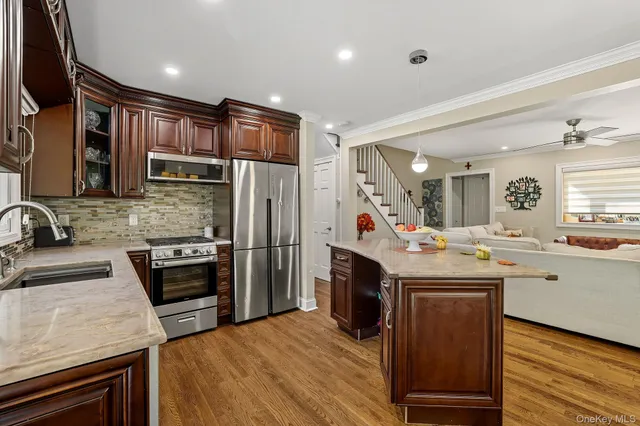 a kitchen with stainless steel appliances granite countertop a sink stove and refrigerator