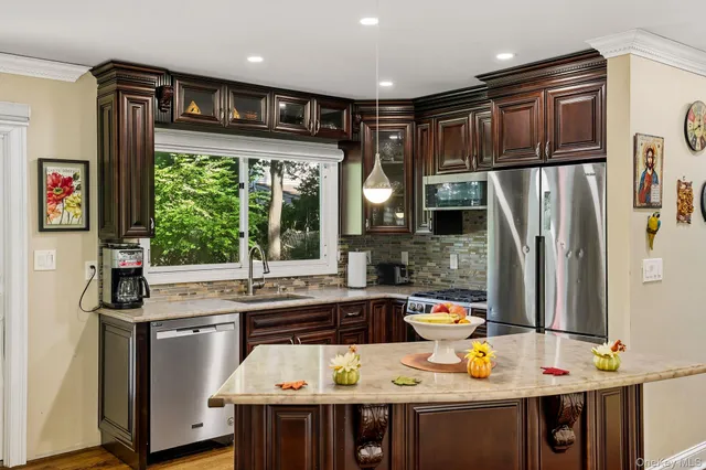 a kitchen with stainless steel appliances a sink stove and refrigerator