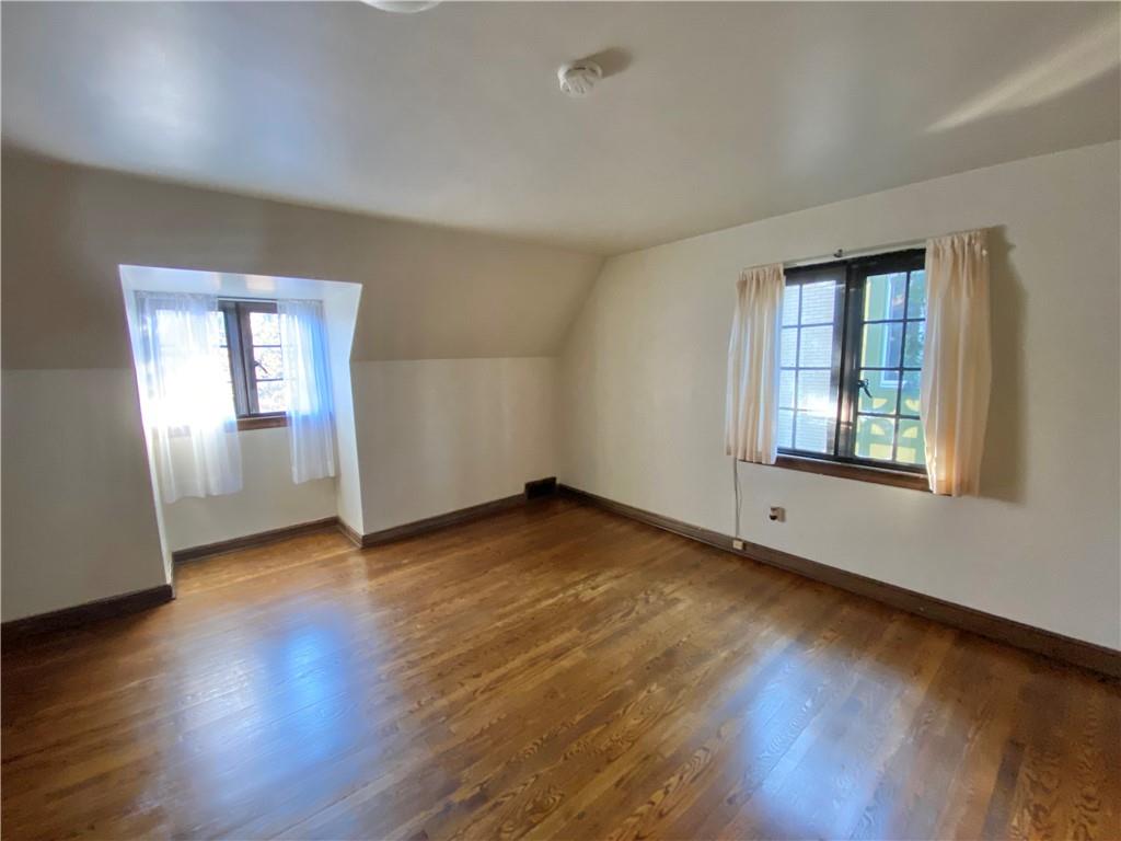 5659 Darlington Road Pittsburgh, PA 15217 - Photo 11 of 25 an empty room with wooden floor and windows
