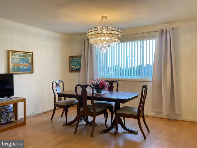 a view of a dining room with furniture and chandelier