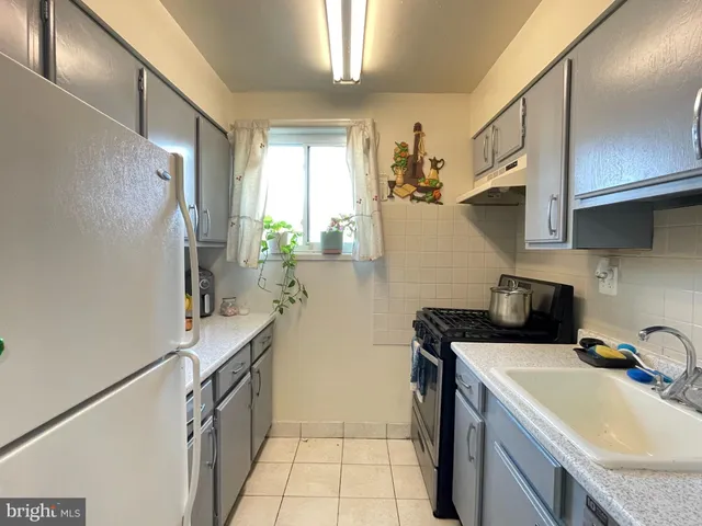 a kitchen that has a sink and a stove in it