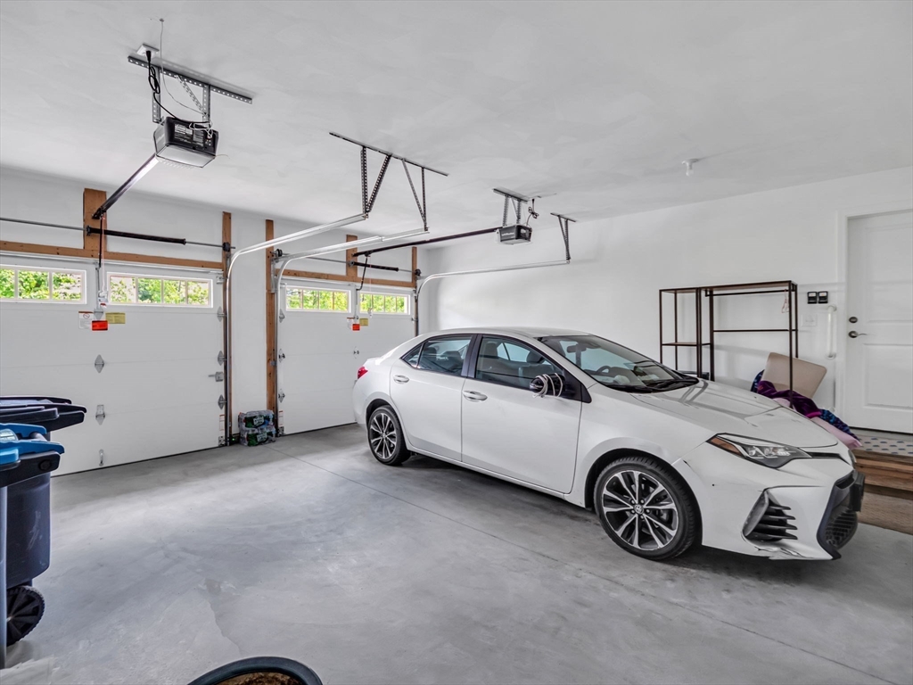 37 Abacoa Road, Unit 37 Hudson, NH 03051 - Photo 24 of 28 a car parked in a garage
