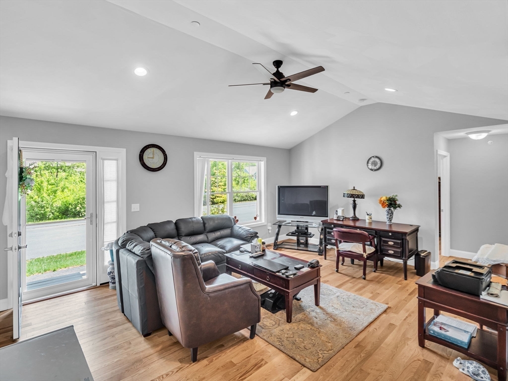 37 Abacoa Road, Unit 37 Hudson, NH 03051 - Photo 8 of 28 a living room with furniture and a flat screen tv
