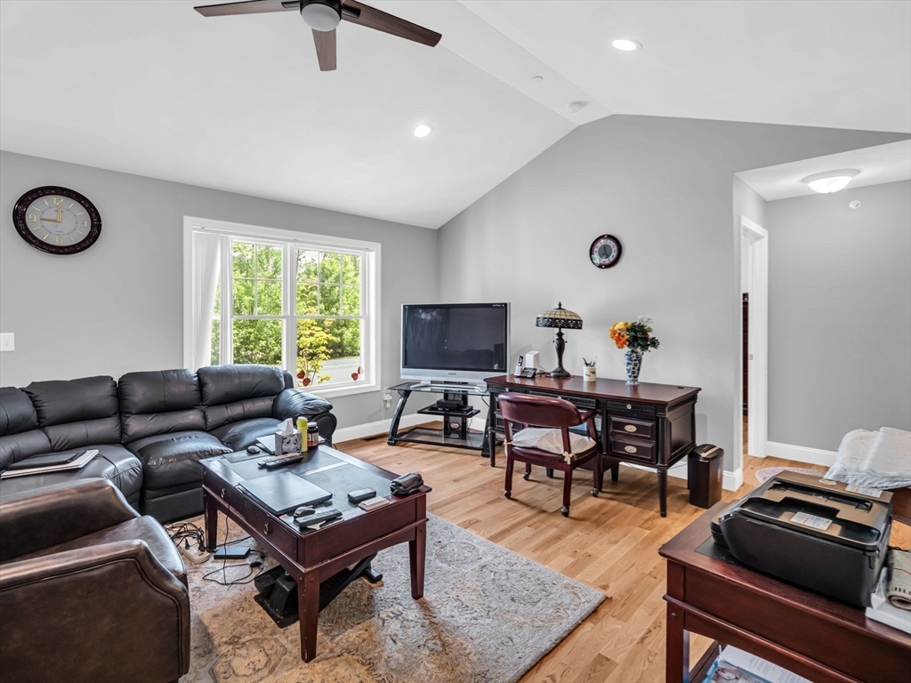 37 Abacoa Road, Unit 37 Hudson, NH 03051 - Photo 9 of 28 a living room with furniture and a wooden floor