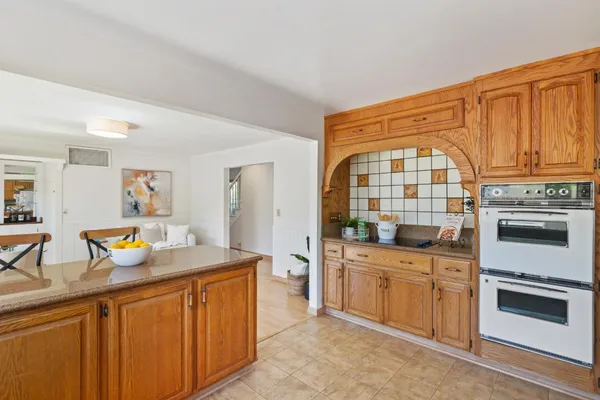 a kitchen with stainless steel appliances a stove a sink and a refrigerator