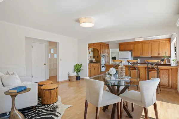 a view of a dining room with furniture and a window