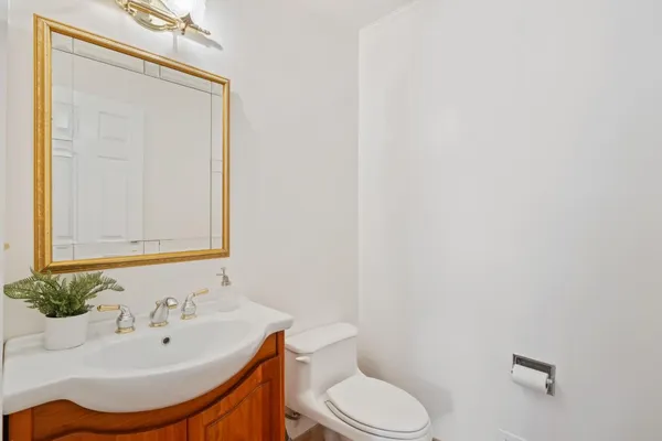 a bathroom with a sink a toilet and mirror