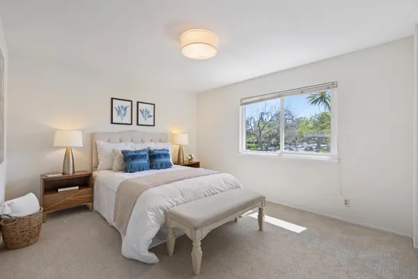 a bedroom with a bed and a painting on the wall