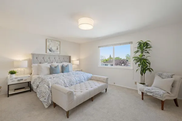 a bedroom with a bed and a couch