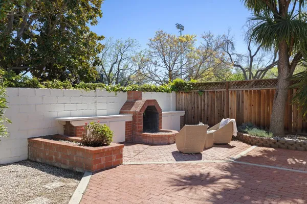 a view of a backyard with furniture and a fire pit