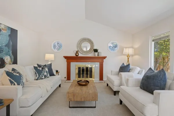 a living room with furniture and a fireplace