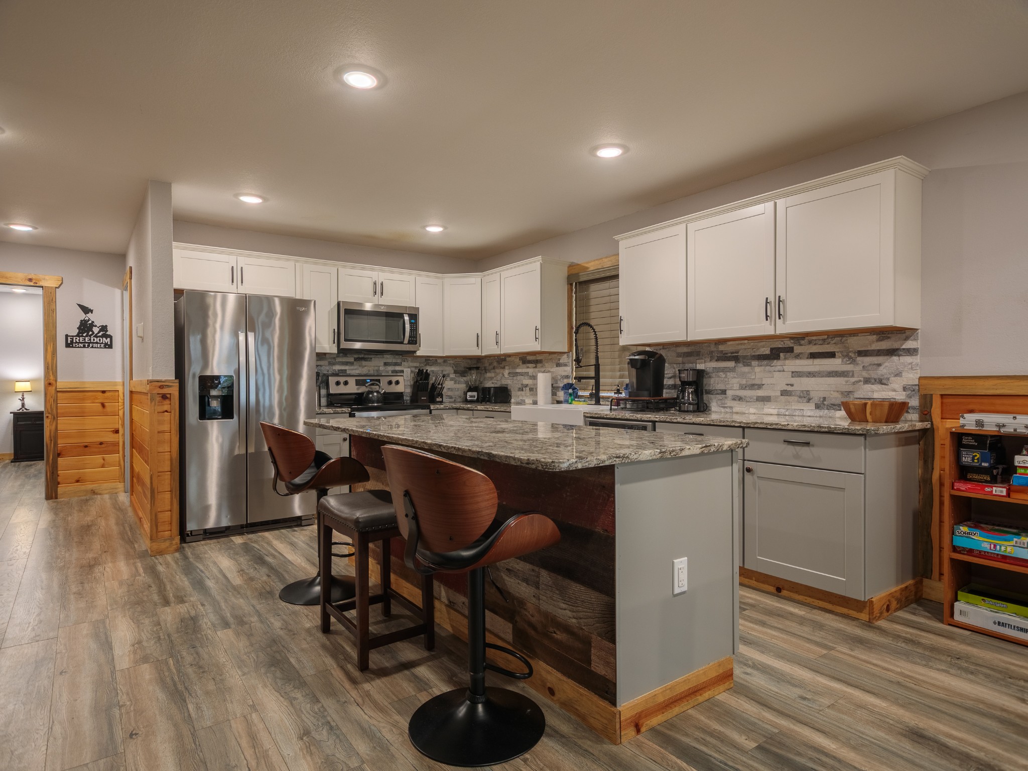 812 Starlight Lane Kodak, TN 37764 - Photo 20 of 60 a kitchen with stainless steel appliances granite countertop a refrigerator a stove top oven a sink dishwasher and white cabinets with wooden floor
