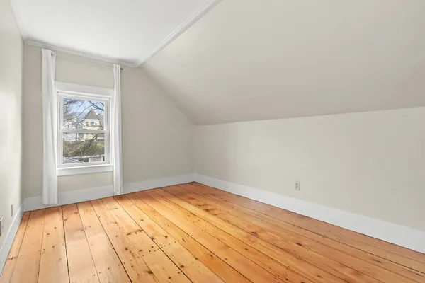 a view of a room with wooden floor