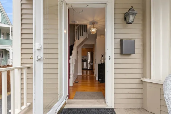 a view of entryway and hall with wooden floor