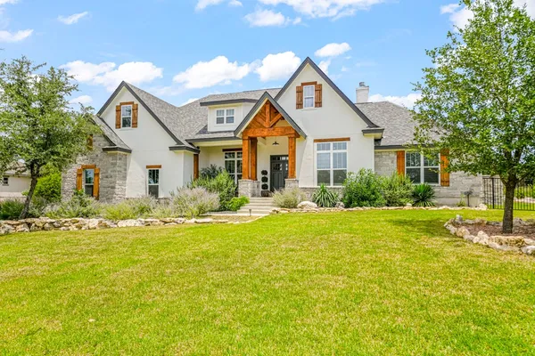 a front view of house with yard and green space