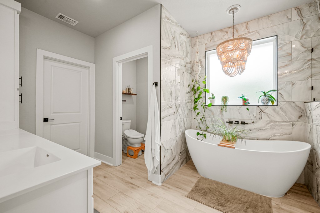 Undisclosed Address Spring Branch, TX 78070 - Photo 15 of 40 a white bath tub sitting in a bathroom and a sink