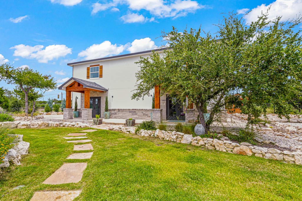 Undisclosed Address Spring Branch, TX 78070 - Photo 29 of 40 a front view of house with yard and outdoor seating