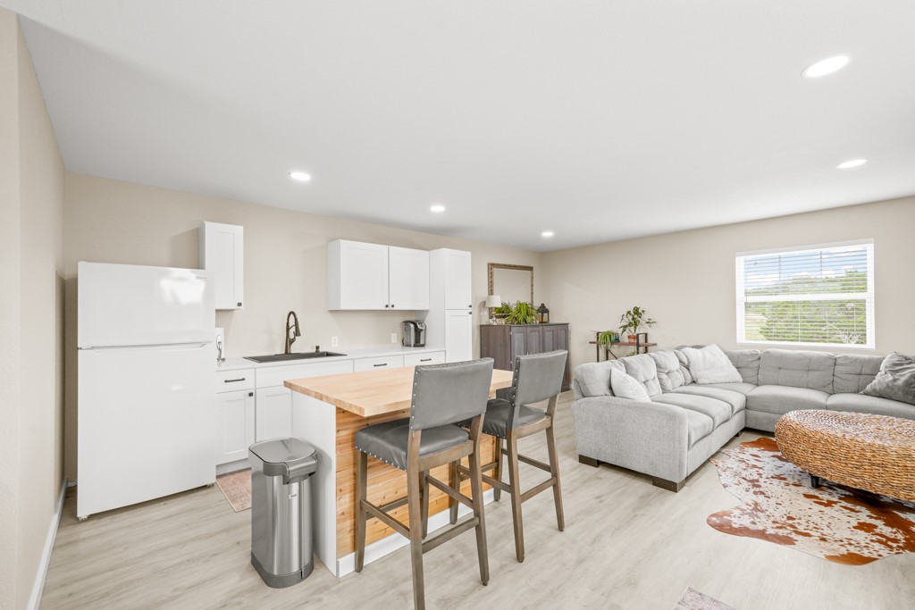 Undisclosed Address Spring Branch, TX 78070 - Photo 38 of 40 a living room with furniture a refrigerator and kitchen view