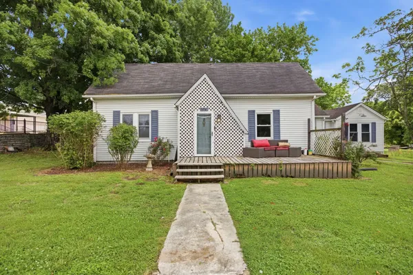 a front view of house with yard and green space