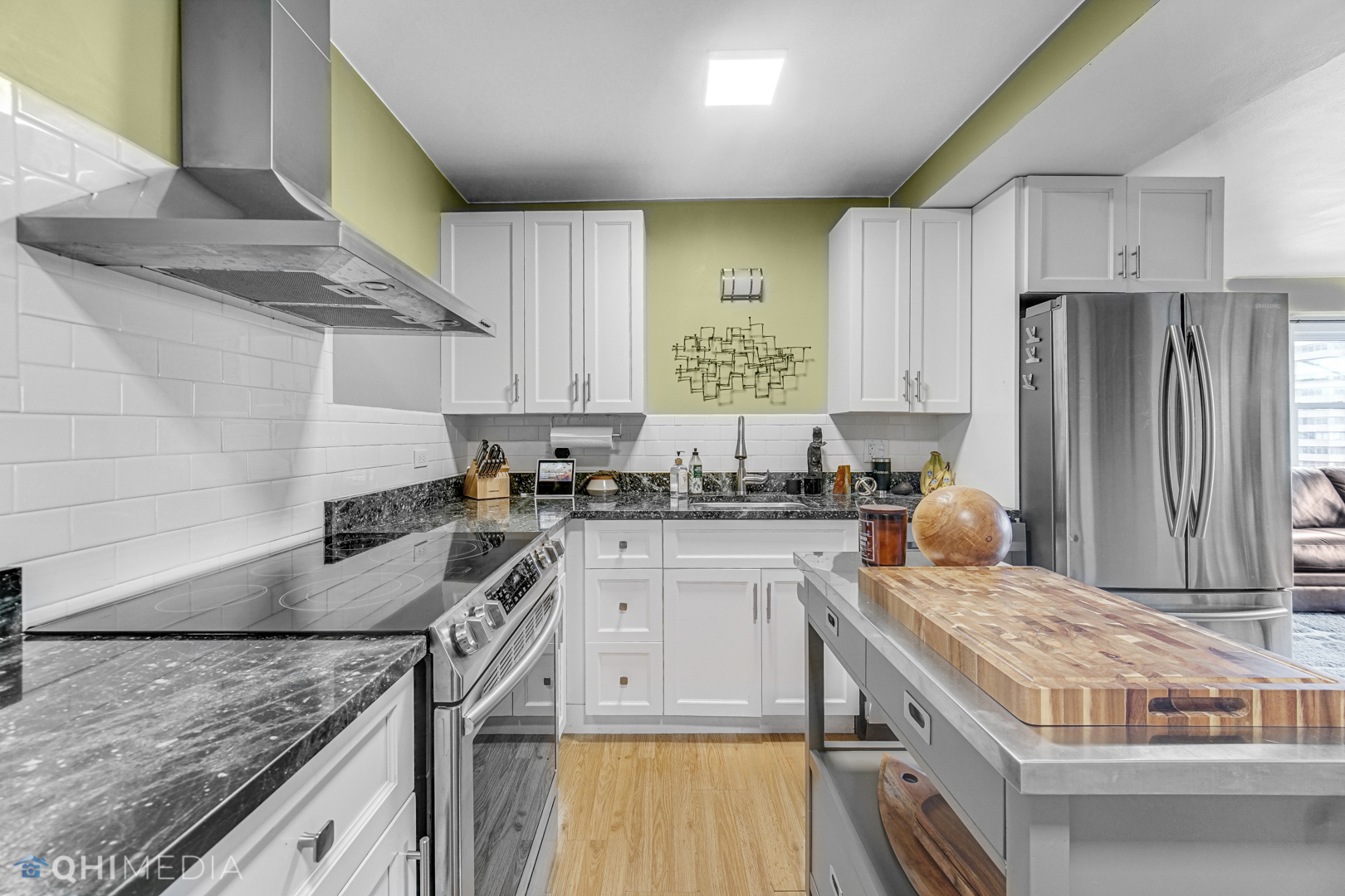 2909 North Sheridan Road, Unit 1502 Chicago, IL 60657 - Photo 2 of 19 a kitchen with stainless steel appliances granite countertop a sink stove and refrigerator