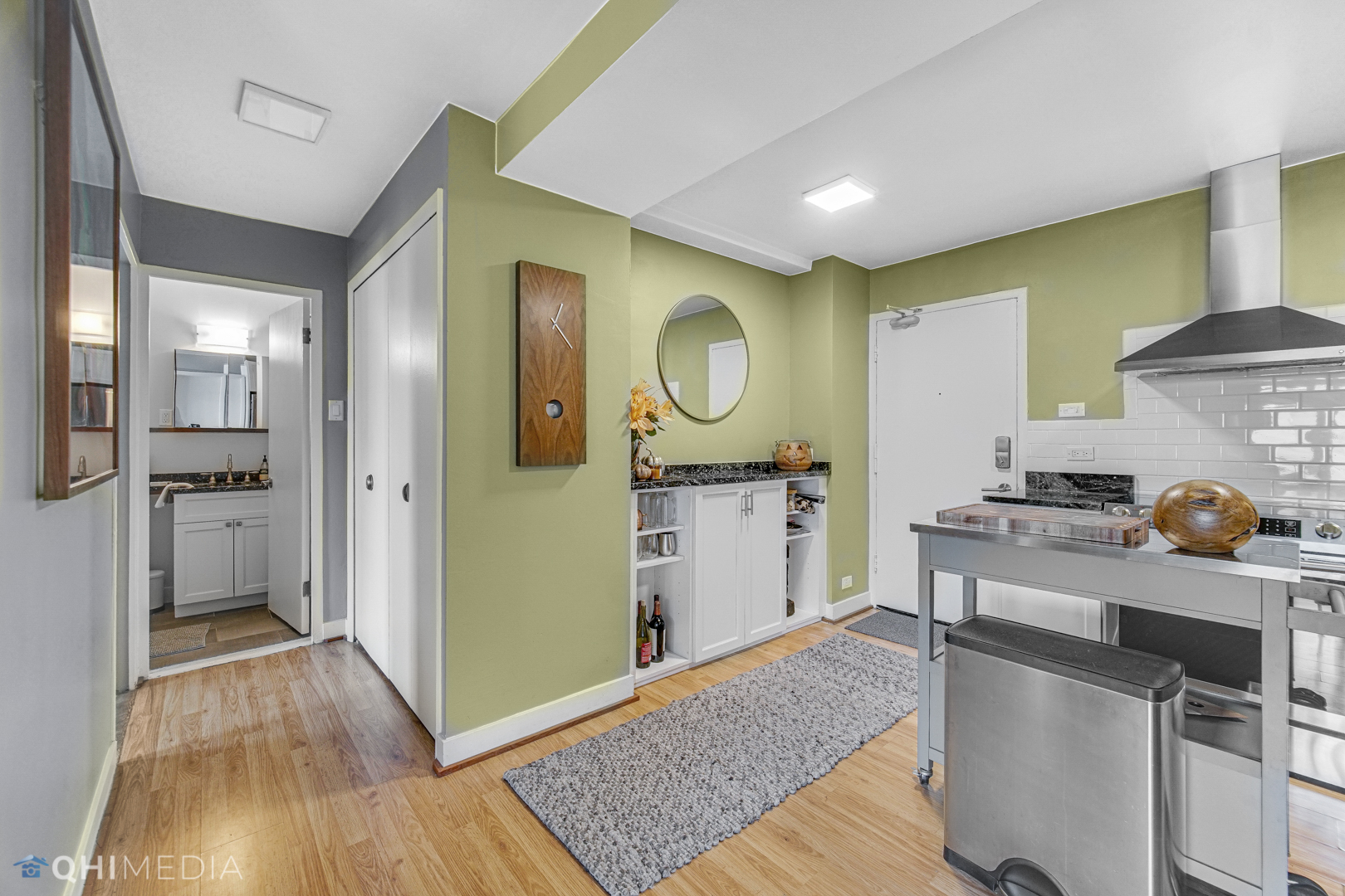 2909 North Sheridan Road, Unit 1502 Chicago, IL 60657 - Photo 14 of 19 a kitchen with a sink cabinets and wooden floor
