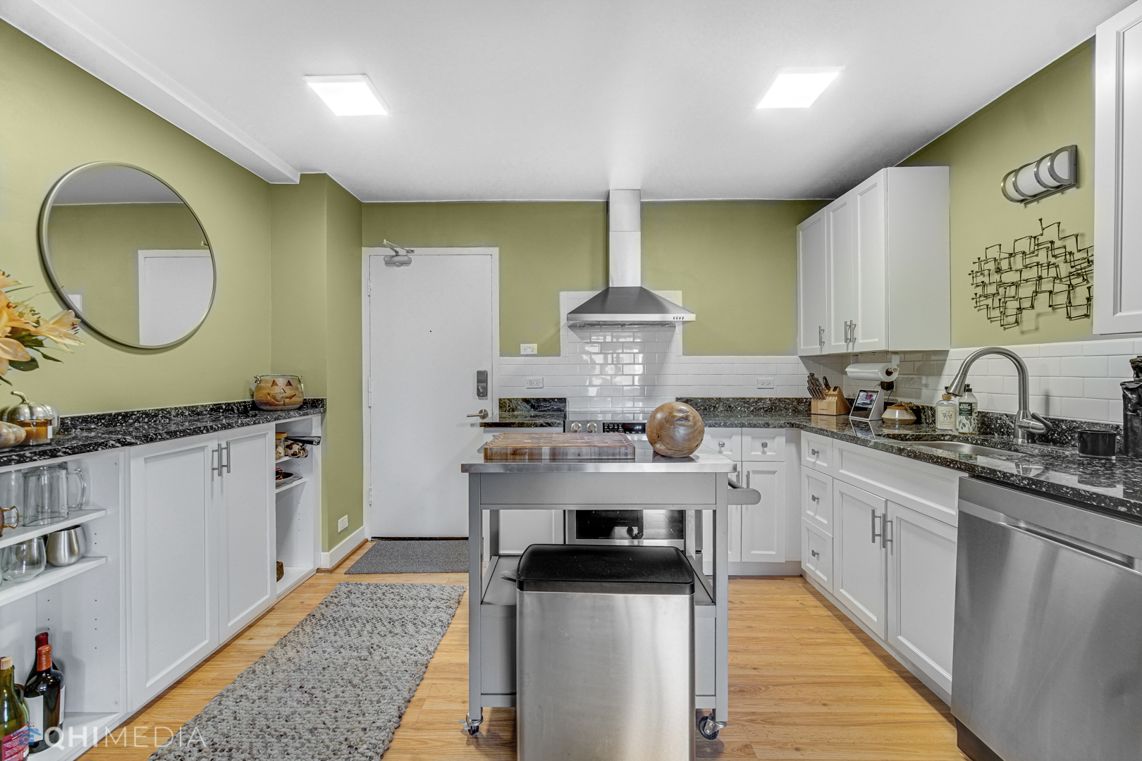 2909 North Sheridan Road, Unit 1502 Chicago, IL 60657 - Photo 4 of 19 a kitchen with stainless steel appliances a sink stove and cabinets