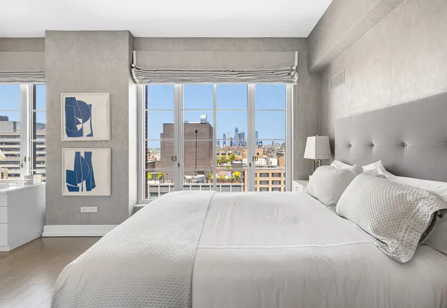 a bedroom with a large bed and a night stand