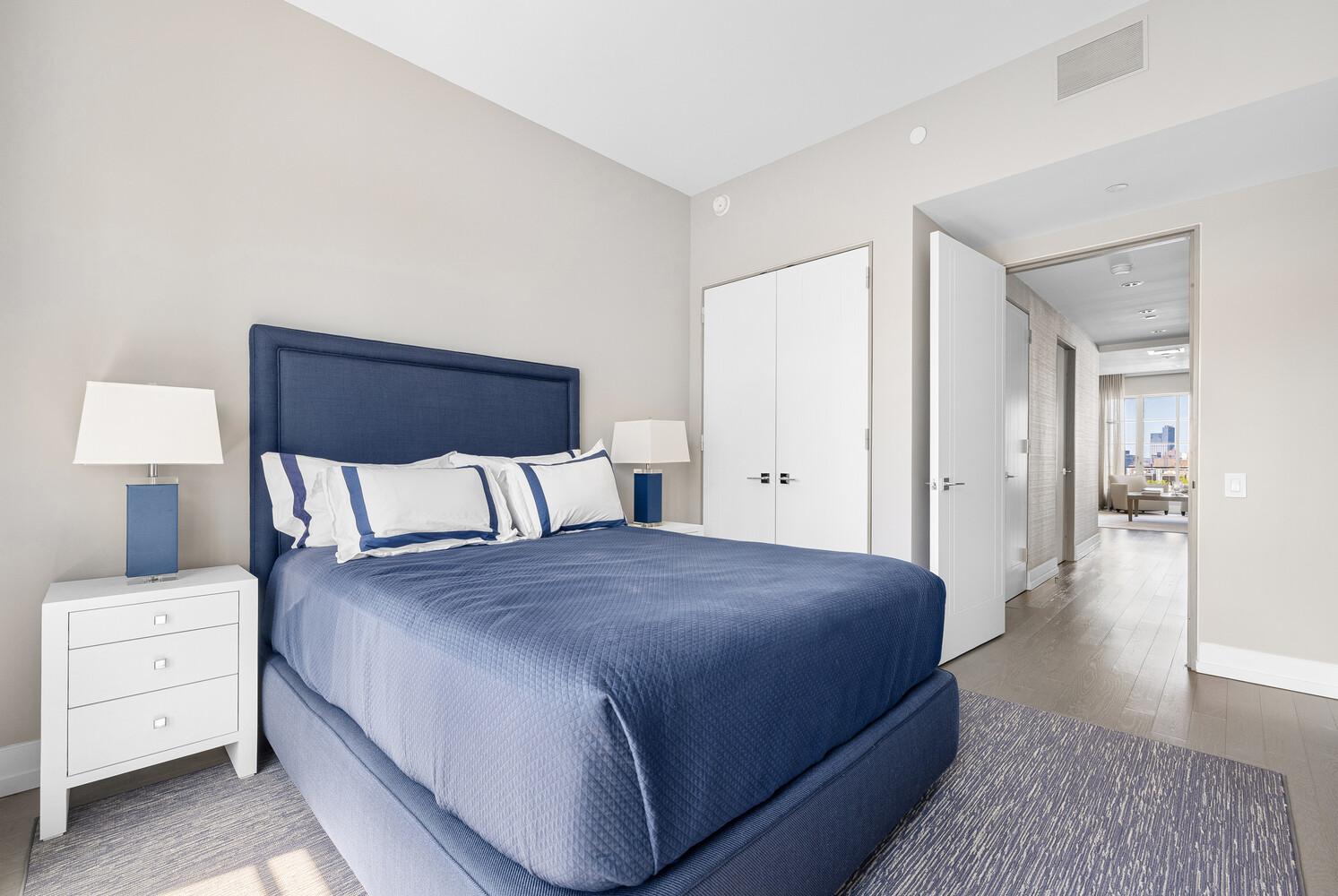 70 Charlton Street, Unit PHC Manhattan, NY 10014 - Photo 12 of 18 a spacious bedroom with a bed and a lamp