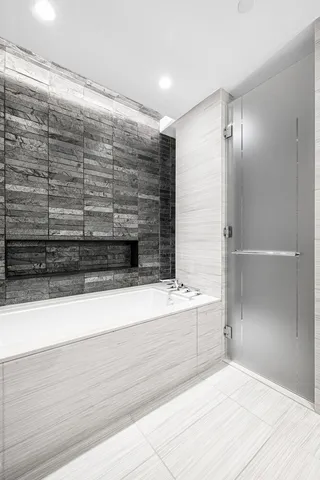 a bathroom with a bathtub and a shower