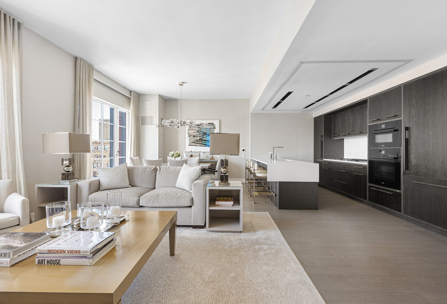 70 Charlton Street, Unit PHC Manhattan, NY 10014 - Photo 3 of 18 a living room with furniture wooden floor and kitchen view