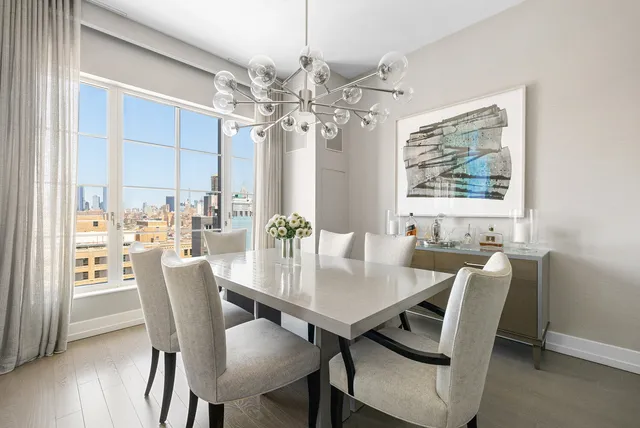 a view of a dining room with furniture window and wooden floor