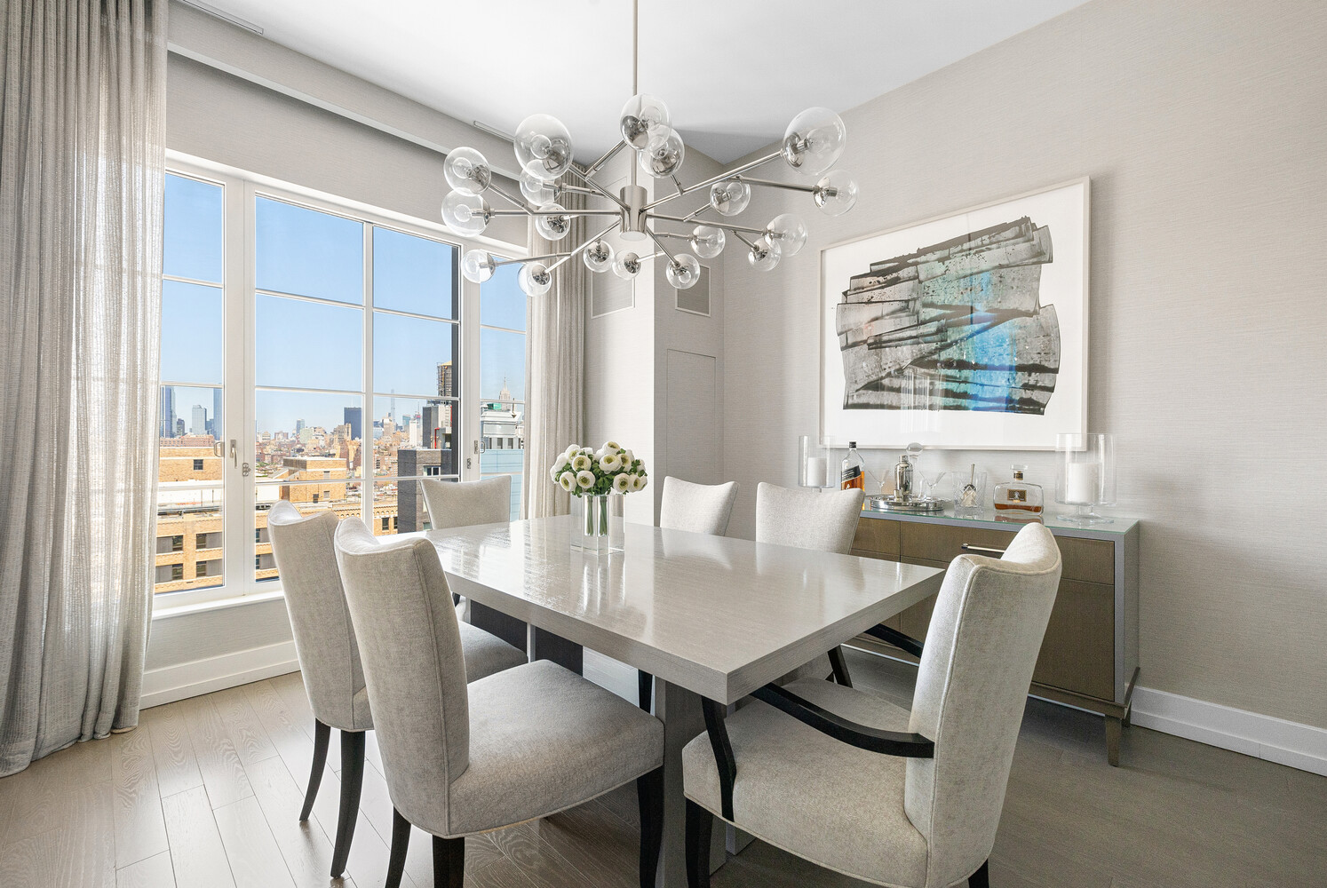 70 Charlton Street, Unit PHC Manhattan, NY 10014 - Photo 5 of 18 a view of a dining room with furniture window and wooden floor