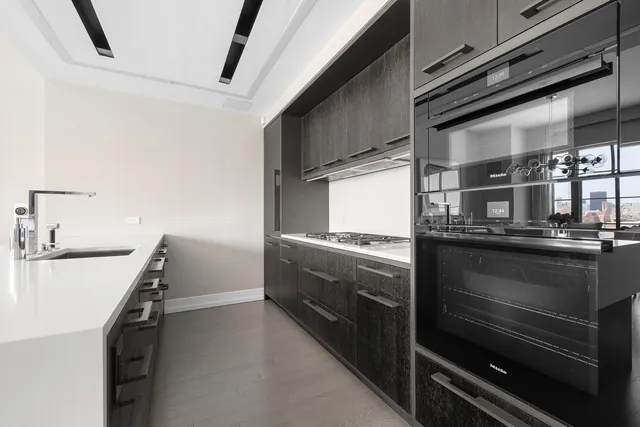 a kitchen with granite countertop a stove and a sink