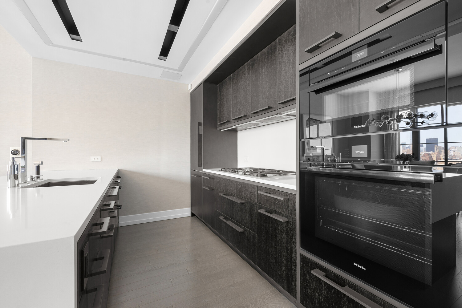 70 Charlton Street, Unit PHC Manhattan, NY 10014 - Photo 8 of 18 a kitchen with granite countertop a stove and a sink