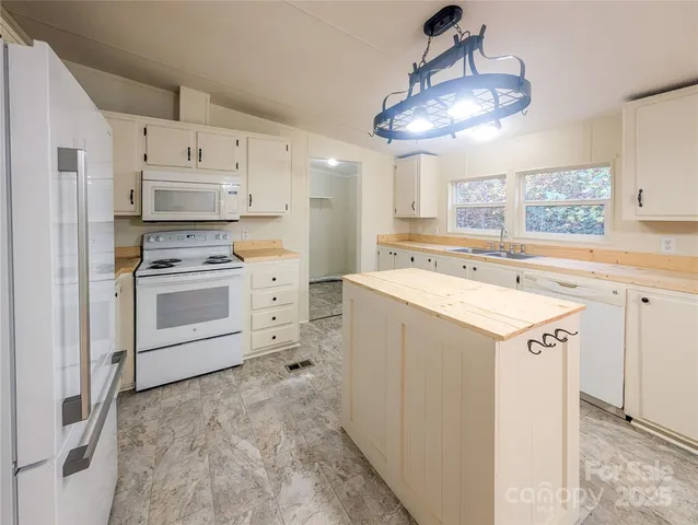 a kitchen with a sink a stove and refrigerator