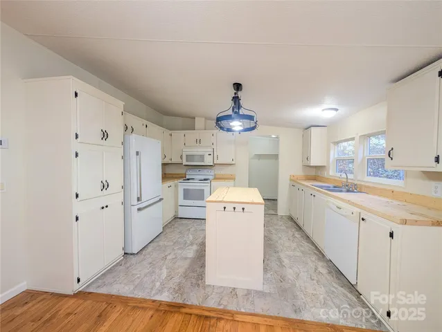 a large white kitchen with cabinets and a stainless steel appliances