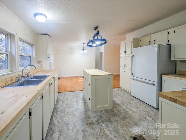 a kitchen with a sink stove and refrigerator