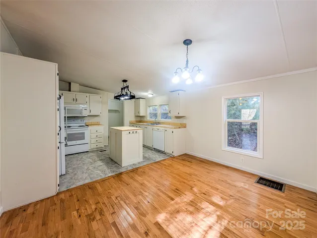 a open kitchen with kitchen island a sink stainless steel appliances and cabinets