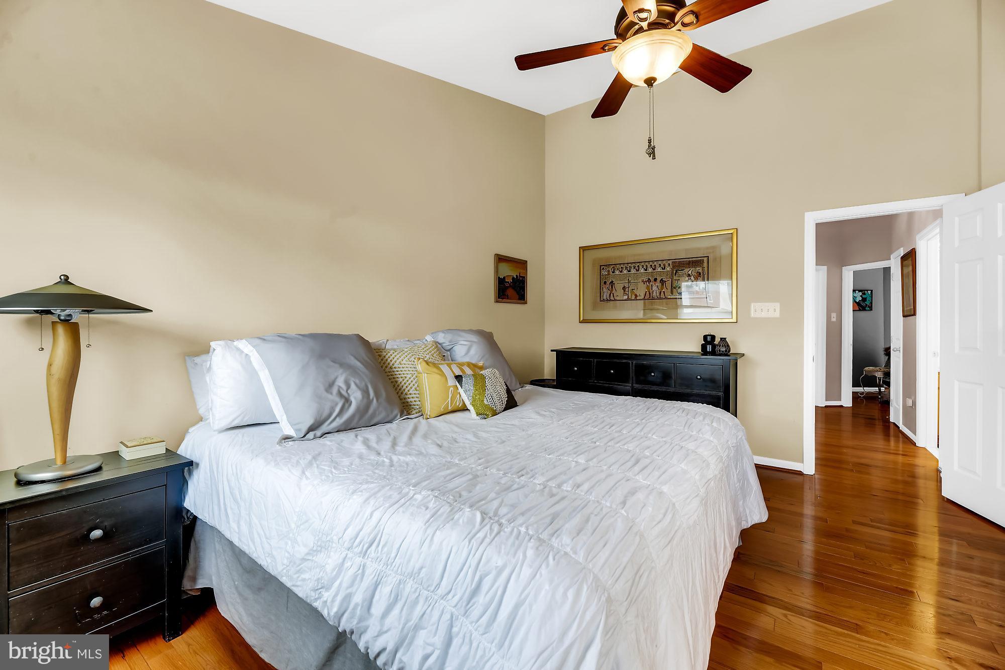 2090 Clipper Park Road Baltimore, MD 21211 - Photo 12 of 75 a bedroom with a bed and wooden floor