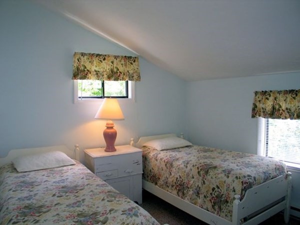 175 Meetinghouse Way Edgartown, MA 02539 - Photo 12 of 21 a bedroom with a bed and window