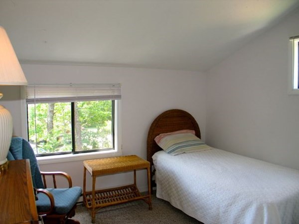 175 Meetinghouse Way Edgartown, MA 02539 - Photo 13 of 21 a bedroom with a bed and a large window