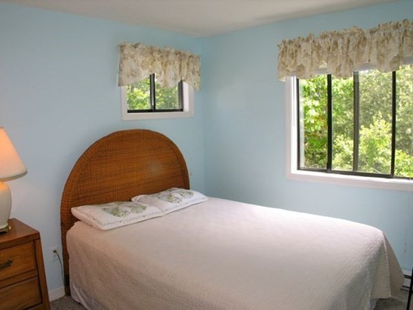 175 Meetinghouse Way Edgartown, MA 02539 - Photo 15 of 21 a bedroom with a bed and a painting on the wall