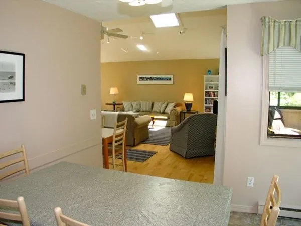 a living room with couches chairs and painted walls