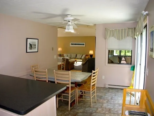 a view of a dining room with furniture and a window
