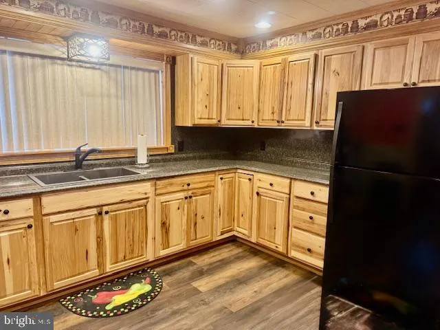 a kitchen with granite countertop a sink a stove and cabinets